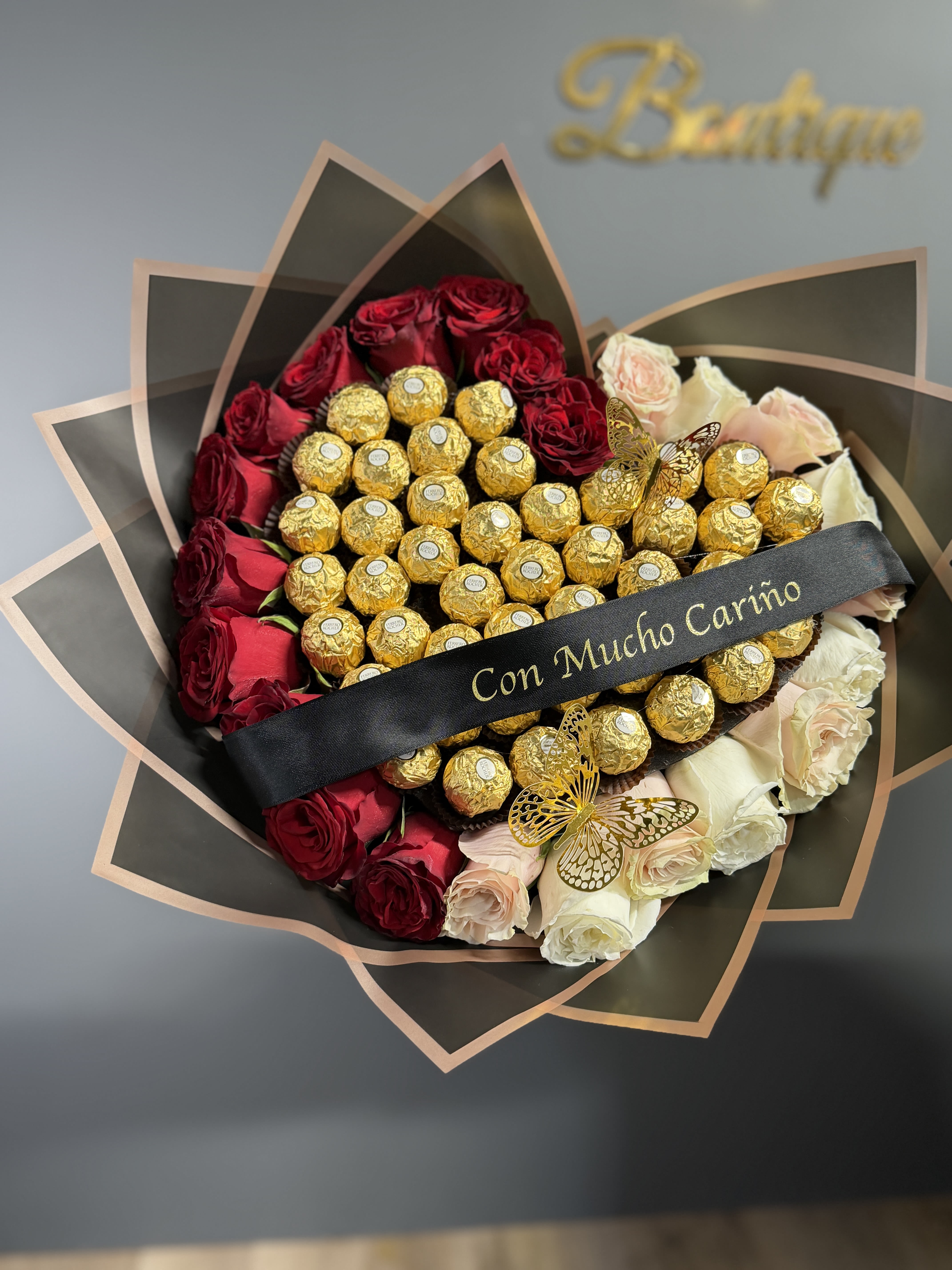 Be Mine Chocolate Heart - Be Mine Heart is a show-stopping heart-shaped wrapped bouquet designed to captivate at first sight. Lush, hand-selected blooms are artfully arranged and paired with luxurious Ferrero chocolates, creating the perfect balance of romance and indulgence. Wrapped with care and elegance, this bouquet is a heartfelt way to say “I love you,” “I’m thinking of you,” or “Be mine,” a sweet and unforgettable gift for life’s most romantic moments.  * Ribbon not included*