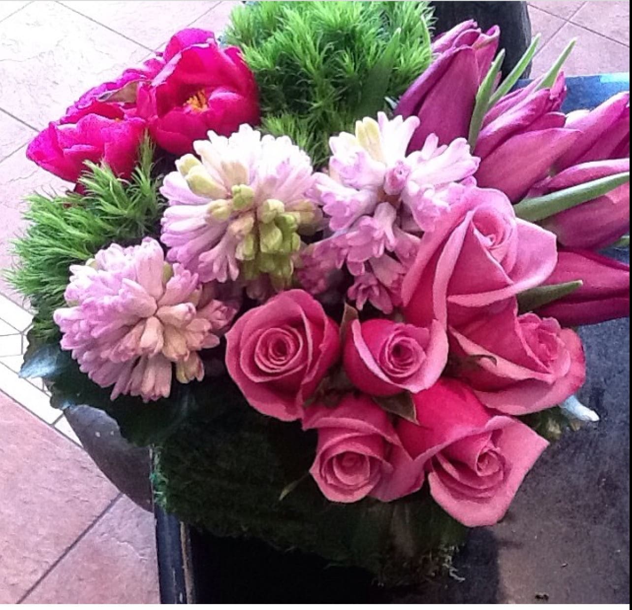 Power of love - Purple tulips, lavender roses, peonies( substitution depends on the season) dianthus  hyacinth ( seasonal) French  compact look in a sauce or cylinder .