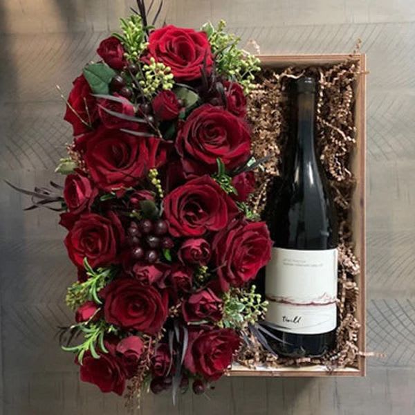 Days of Wine &amp; Roses - A beautiful pairing! Surprise your sweetheart with this classic combination of wine and roses. We have paired a 2018 Pinot Noir from our favorite local winery, Amaterra, with an arrangement of lush red roses and spray roses all in a reusable custom made wood box.  For an extra touch of romance, add a candle, chocolates!  PLEASE NOTE: Flower varieties will vary slightly due to availability but the over all aesthetic of the arrangement will stay the same. Our designers always select the freshest blooms for your arrangement.    