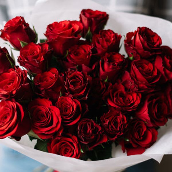 Handcrafted Bouquet of Red Roses - 12 beautiful red roses are artfully arranged in this handcrafted bouquet and wrapped with tissue, kraft paper and tied with a coordinating ribbon.  Standard - 1 dozen roses  Deluxe - 18 roses  Premium - 2 dozen roses  PLEASE NOTE: THIS SELECTION COMES WITHOUT A VASE