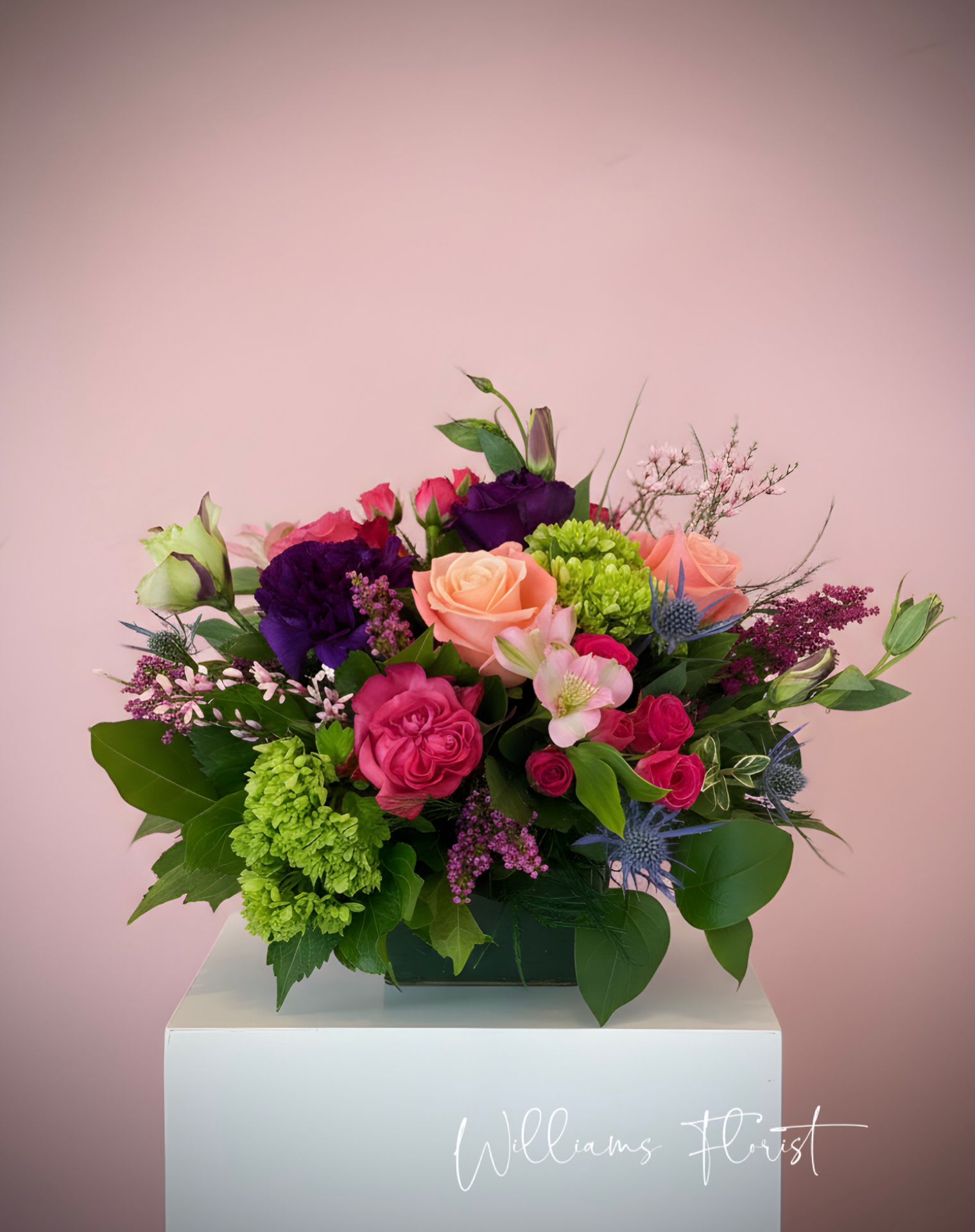 Spring Fling - This arrangement includes hot pink roses, pink roses, green hydrangea, alstro, lisianthus, purple statice. Spring Fling is a great gift for a birthday, get well, or just because. 