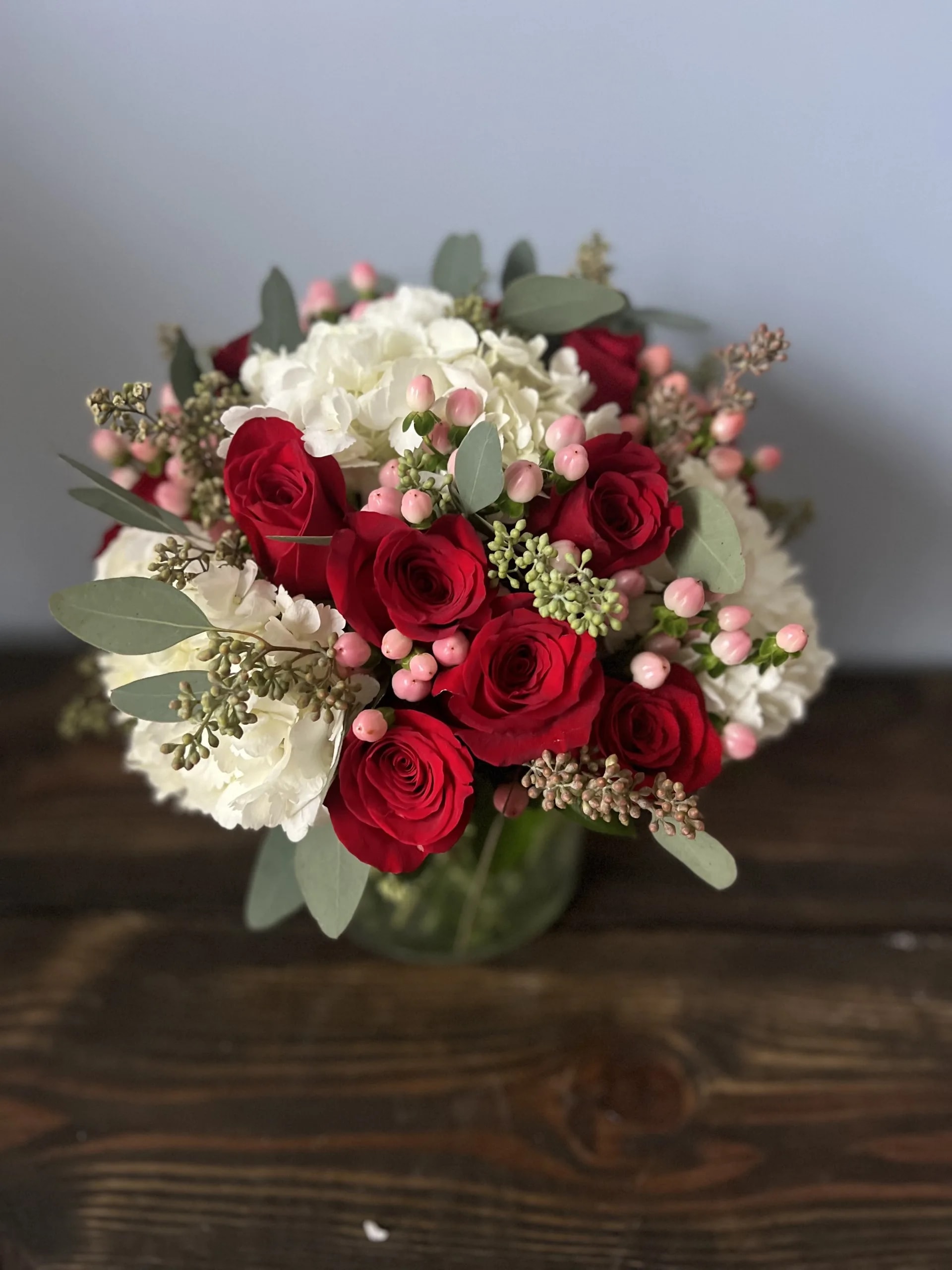 Be Mine - 18 red roses with a mix of pink hypericum and white hydrangea.  A favorite for all!