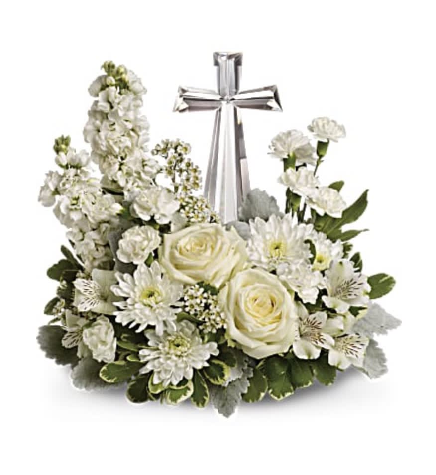 Crystal Cross Bouquet  - An elegant display of faith and divine peace, this beautiful arrangement will comfort the bereaved in a truly thoughtful and respectful way. An exquisite crystal cross is surrounded by a bed of lovely blossoms. It is sure to be appreciated and always remembered.   Please note the bouquet pictured reflects our original design for this product while we always try to follow the color palette we may replace stems to deliver the freshest bouquet possible. 