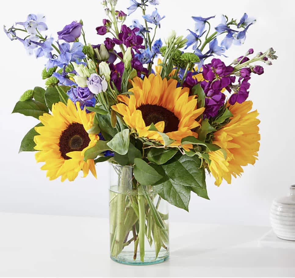 Catching Rays Bouguet - Travel to a warm summer day with the Catching Rays Bouquet, a glorious blend of yellow, blue and purple florals.  Pet Safety Precautions: This bouquet or plant may include flowers and foliage that are known to be toxic to pets. To keep them safe, be sure to keep this arrangement out of your pet's reach.   SUBSTITUTION POLICY Always deliver the freshest flowers! Please note the bouquet pictured reflects our original design.  If the exact flowers or container in this arrangement are not available, our local florists will create a beautiful bouquet with the freshest available flowers.