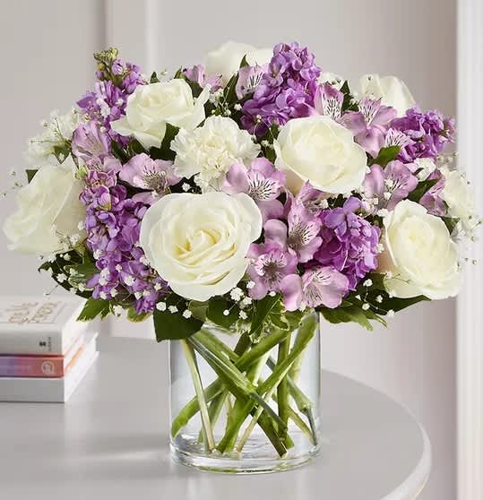 Lavender &amp; White bouquet - A loving sentiment can bring comfort during a time of loss. Our arrangement of soothing lavender and white blooms is hand-designed by our florists to help you express your heartfelt condolences.