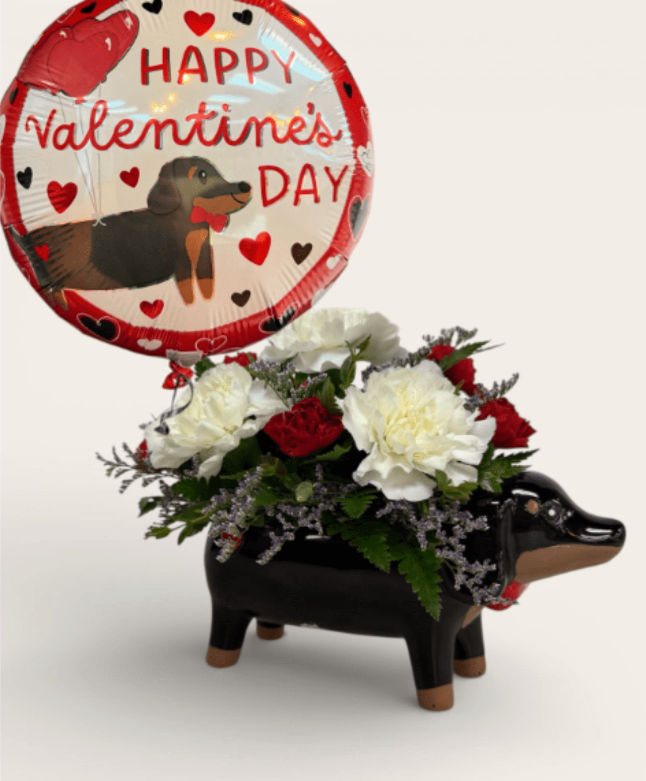 Oscar Buzz - Oscar Buzz is ready for its close-up! This Hollywood-inspired arrangement features an adorable wiener dog design brought to life with carnations and mini carnations, paired with a coordinating Mylar balloon for extra star power.