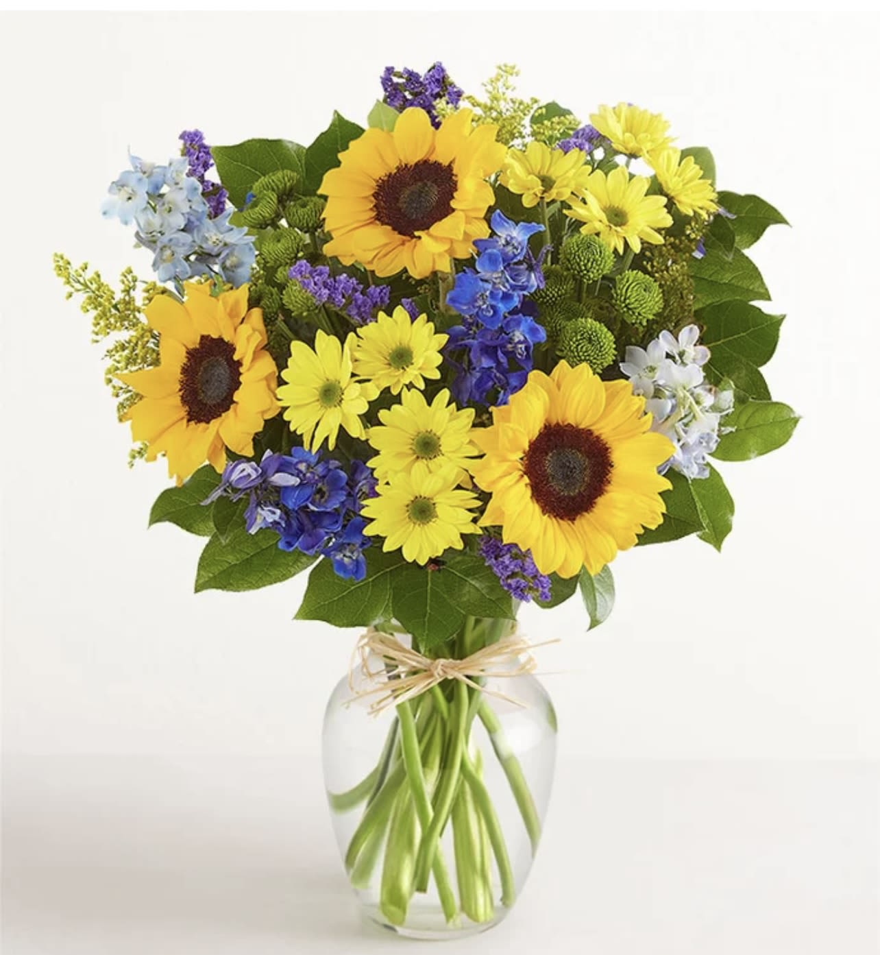 Fields of Europe Summer - Inspired by the colorful charm of the European countryside, a summer bouquet is gathered with fresh-picked blooms, revealing the rustic beauty of nature. Shades of golden yellow and rich blue pop against lush greenery, creating a timeless gift for someone special to enjoy.   SUBSTITUTION POLICY Always deliver the freshest flowers! Please note the bouquet pictured reflects our original design.  If the exact flowers or container in this arrangement are not available, our local florists will create a beautiful bouquet with the freshest available flowers.