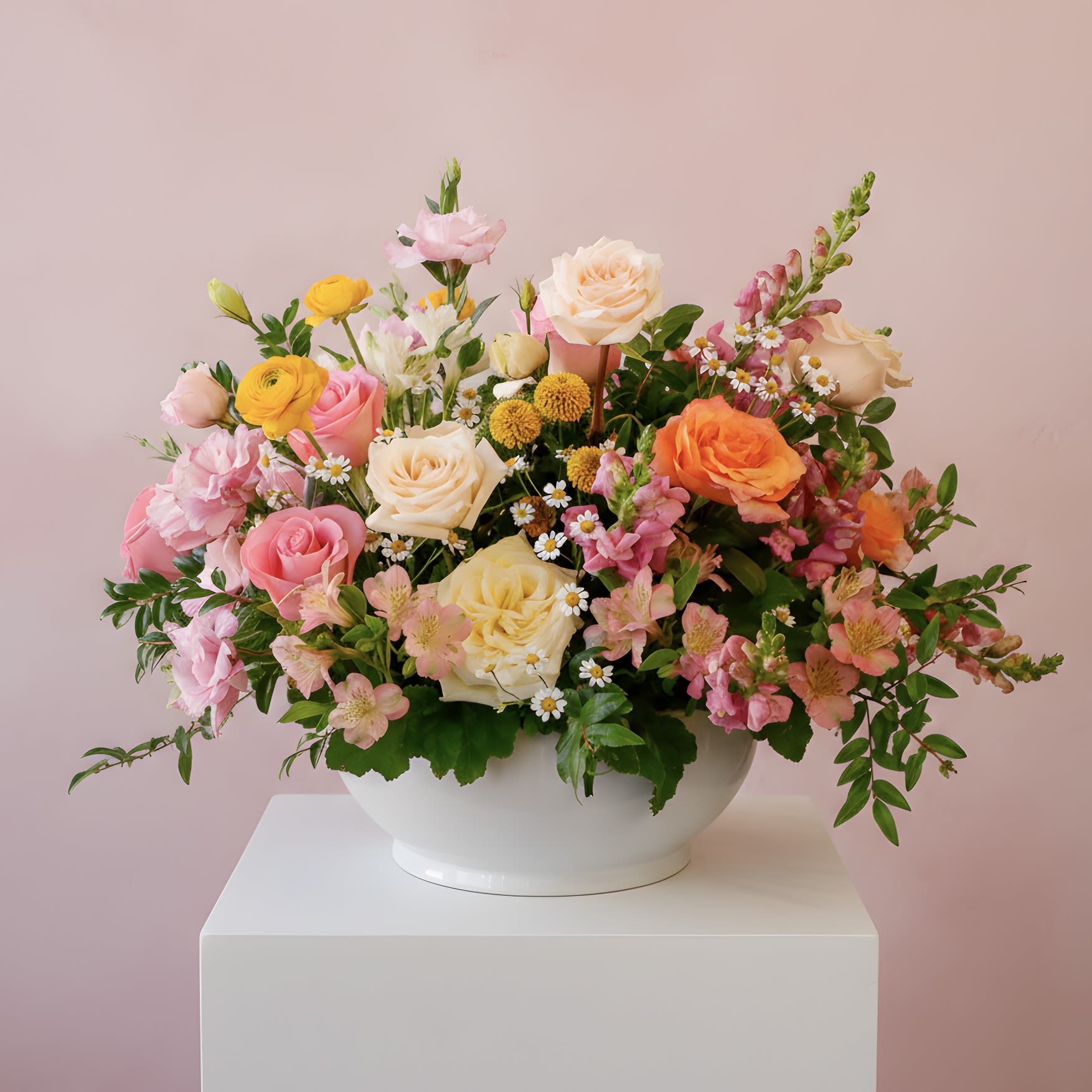 Free Spirit - Free Spirit is a vibrant garden-inspired arrangement designed in a luminous palette of soft pink, butter yellow, warm peach, and creamy ivory. Featuring premium roses, ranunculus, lisianthus, snapdragons, seasonal accent blooms, and lush greenery, this arrangement offers rich texture, natural movement, and joyful sophistication. Styled in a modern white ceramic bowl, it makes a stunning statement for birthdays, celebrations, thank-you gifts, or elevated everyday moments.  Handcrafted by our floral designers in West Los Angeles, Free Spirit is available for flower delivery throughout Santa Monica, Beverly Hills, Brentwood, Westwood, Pacific Palisades, Culver City, and surrounding Los Angeles neighborhoods. A perfect choice for those who love garden-style florals, layered color palettes, and refined LA design.