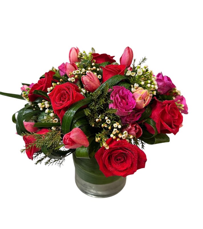 Romence Bouquet - Red  and Pink Roses, Tulips with greens in a Vase Flowers that are high quality, fresh, and beautiful. While we may seasonally need to substitute for flower variety also we may sometimes need to use a different vase or different greens for sub material.