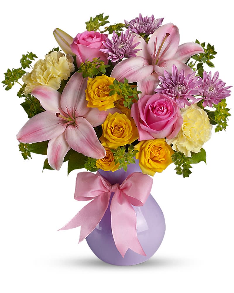 Teleflora's Perfectly Pastel - "Graceful and gorgeous" describes this stunning array of pastel flowers in a charming lavender vase tied with a pink satin ribbon. It's almost too pretty for words. But you'll hear many words of praise for sending it. The elegant bouquet features pink Asiatic lilies, yellow carnations, lavender cushion spray chrysanthemums, yellow spray roses and pink roses accented with assorted greenery. Delivered in a lavender plastic vase tied with a pink satin ribbon.