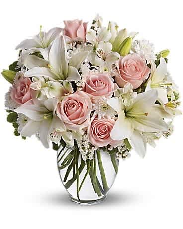 Heavenly Grace Bouquet - his bouquet of soft pink roses, white lilies, and delicate filler flowers has a very romantic and elegant vibe — perfect for weddings, anniversaries, new baby celebrations, or sympathy. Same-day flower delivery in The Colony, Frisco, Little Elm &amp; all DFW.”