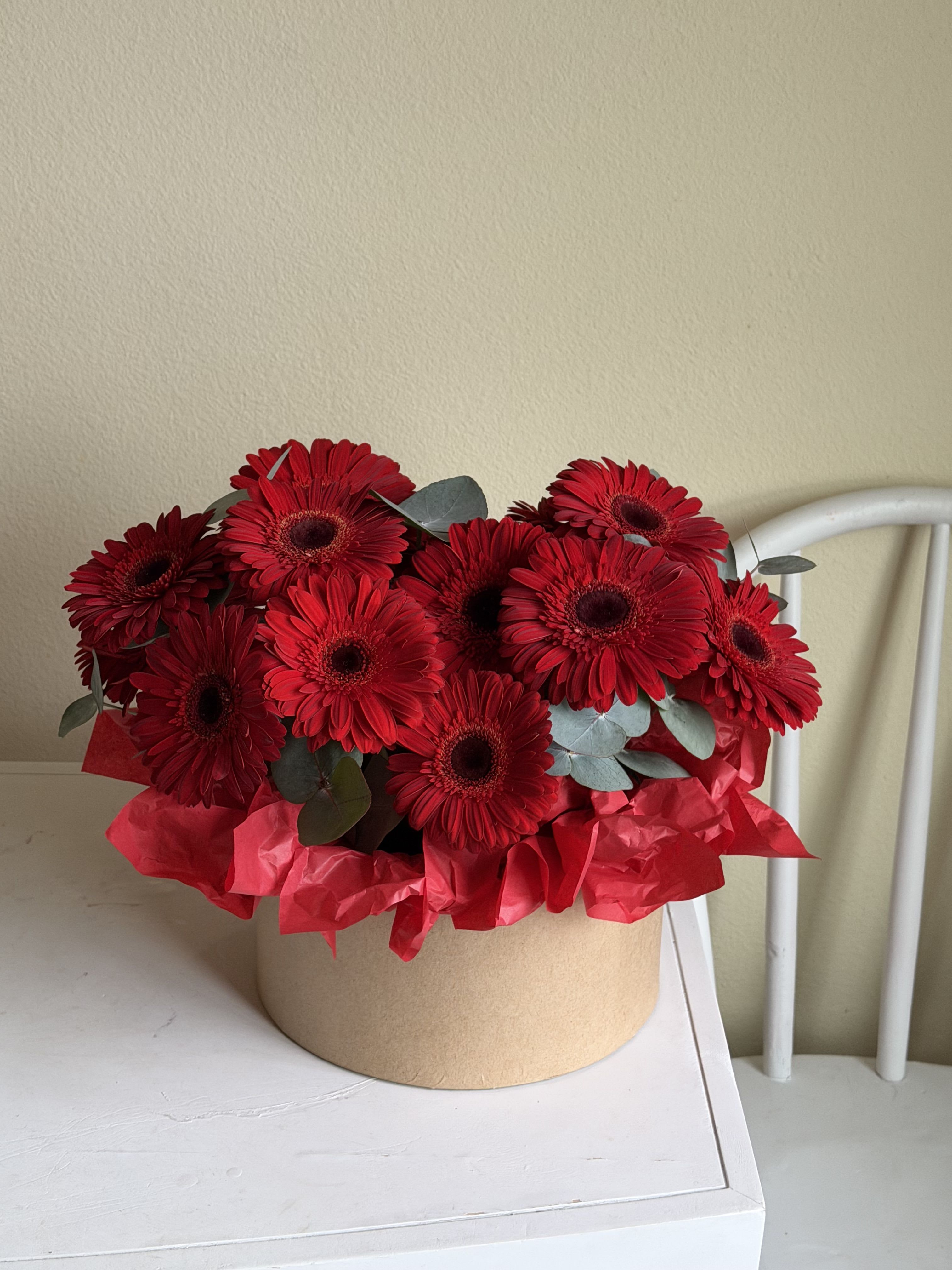 A beautiful box with gerberas - A beautiful box with gerberas is a gentle yet expressive floral composition that speaks the language of joy, warmth, and sincere emotions. Gerberas are flowers that instantly bring light into any space — they symbolize happiness, admiration, positivity, and heartfelt care.  Each box is thoughtfully designed by our florists to create a balanced and elegant arrangement. The velvety petals of gerberas, known for their rich colors and perfectly shaped blooms, are carefully placed inside a stylish floral box, making the bouquet look modern, refined, and effortlessly beautiful.  This floral box is perfect for any occasion — birthdays, anniversaries, thank-you gifts, romantic surprises, or simply as a way to say “I’m thinking of you.” Gerberas have a unique ability to brighten someone’s day and bring a genuine smile, making them a wonderful choice for both joyful moments and warm everyday gestures.  We use only fresh, premium-quality flowers to ensure long-lasting beauty and freshness. The sturdy box not only enhances the presentation but also keeps the arrangement comfortable and easy to display — no vase required. It’s a practical yet luxurious gift that fits seamlessly into any interior.  A beautiful box with gerberas is more than just flowers — it’s a feeling wrapped in color, care, and elegance. A gift that radiates warmth, positivity, and natural beauty from the very first glance.