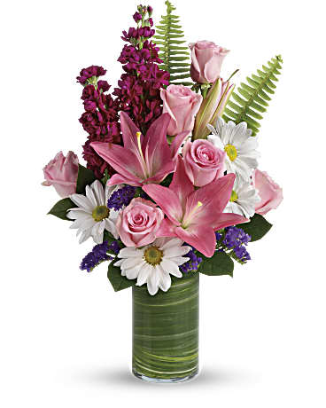 Teleflora's Playful Daisy Bouquet - Bright white daisies dance with happy pink lilies and fabulous fuchsia stock in this playful bouquet! Wrapped with a ti leaf in a modern cylinder vase, it's a joyful gift for any occasion. Pink asiatic lilies, fuchsia stock, white daisy spray chrysanthemums, and raspberry sinuata statice are accented with sword fern, variegated ti leaf, and lemon leaf. Delivered in a Clear Glass Cylinder vase.