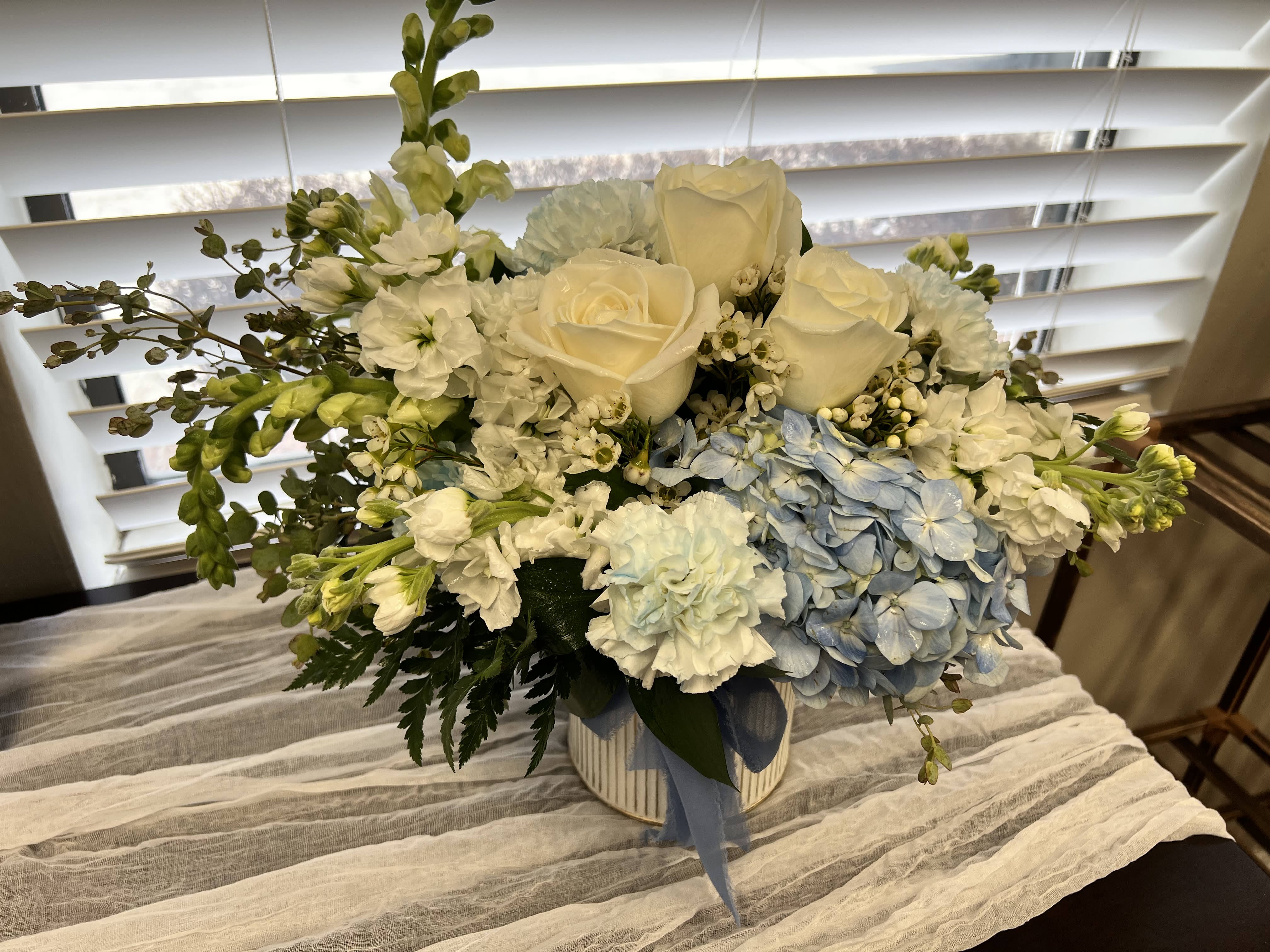 The BYU Embrace -  The BYU Spirit Arrangement  Created with love and intention, this stunning floral design is more than just an arrangement—it’s a heartfelt reminder that no matter how far from home you are, you’re never forgotten. Perfect for BYU students living away, it’s a thoughtful way to say “We see how hard you’re working, and we’re so proud of you.” And let’s not forget the amazing alumni who continue to carry the BYU spirit wherever life takes them. This arrangement is a beautiful celebration of community, dedication, and the lasting pride of being part of the BYU family. Gorgeous, meaningful, and unforgettable—it’s the perfect gift to show love, encouragement, and connection across any distance. 