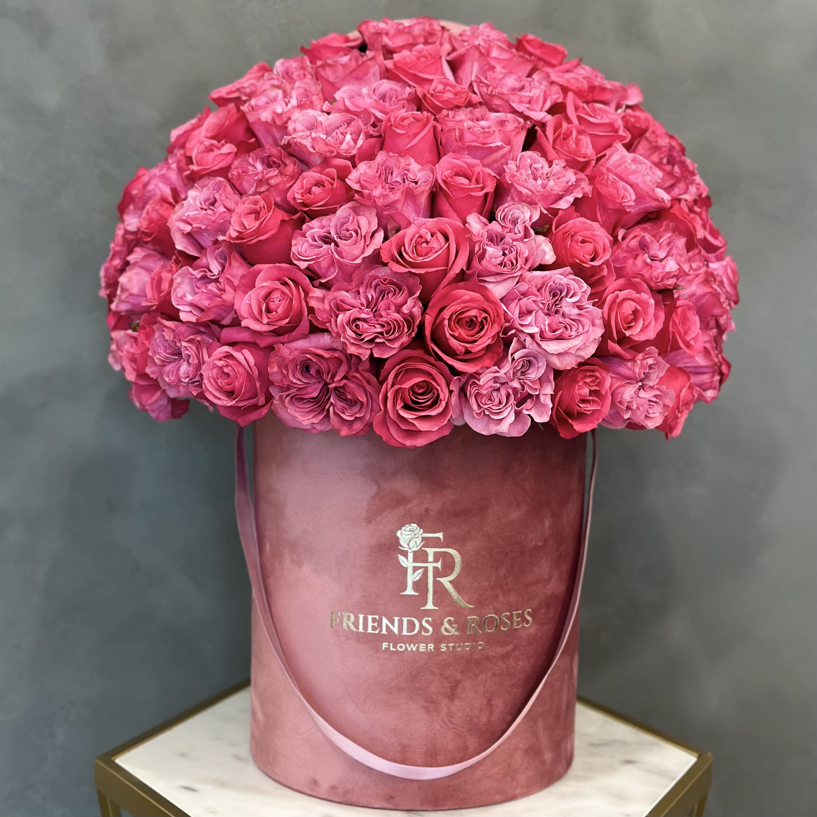 Gloria - Two kinds of pink roses in a dark pink signature box—the perfect pink combination for any occasion. Pictured Deluxe box