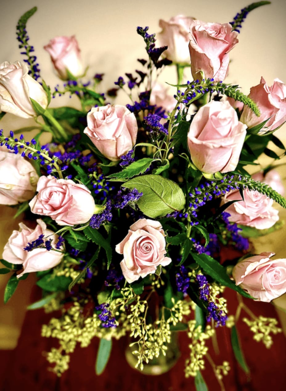 Lovely and Pink - A stunning bouquet of pink roses with delicate purple accents and lush greenery, perfect for expressing love and affection this Valentine’s Day. 
