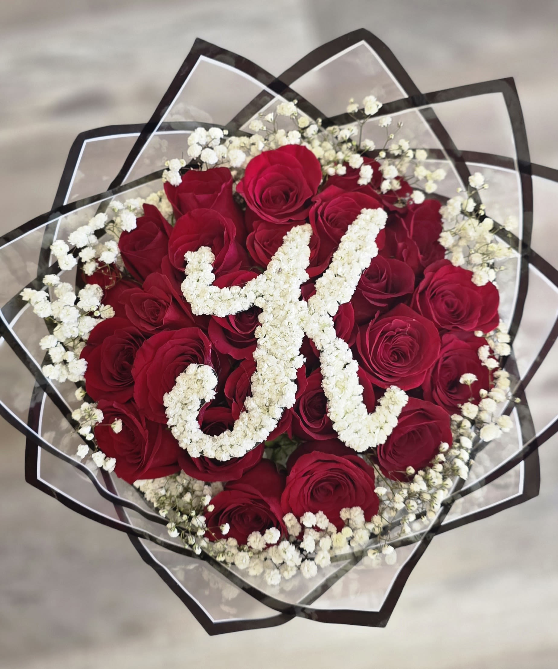 V Day Rose Bouquet 4 - Our 25/50/75 Stem Rose Bouquet with custom baby's breath initial and baby's breath around roses delivers elegance, romance, and wow-factor in every bloom. Limited availability – order early!  If you would like to customize a rose bouquet, please contact us today at 772-249-5688