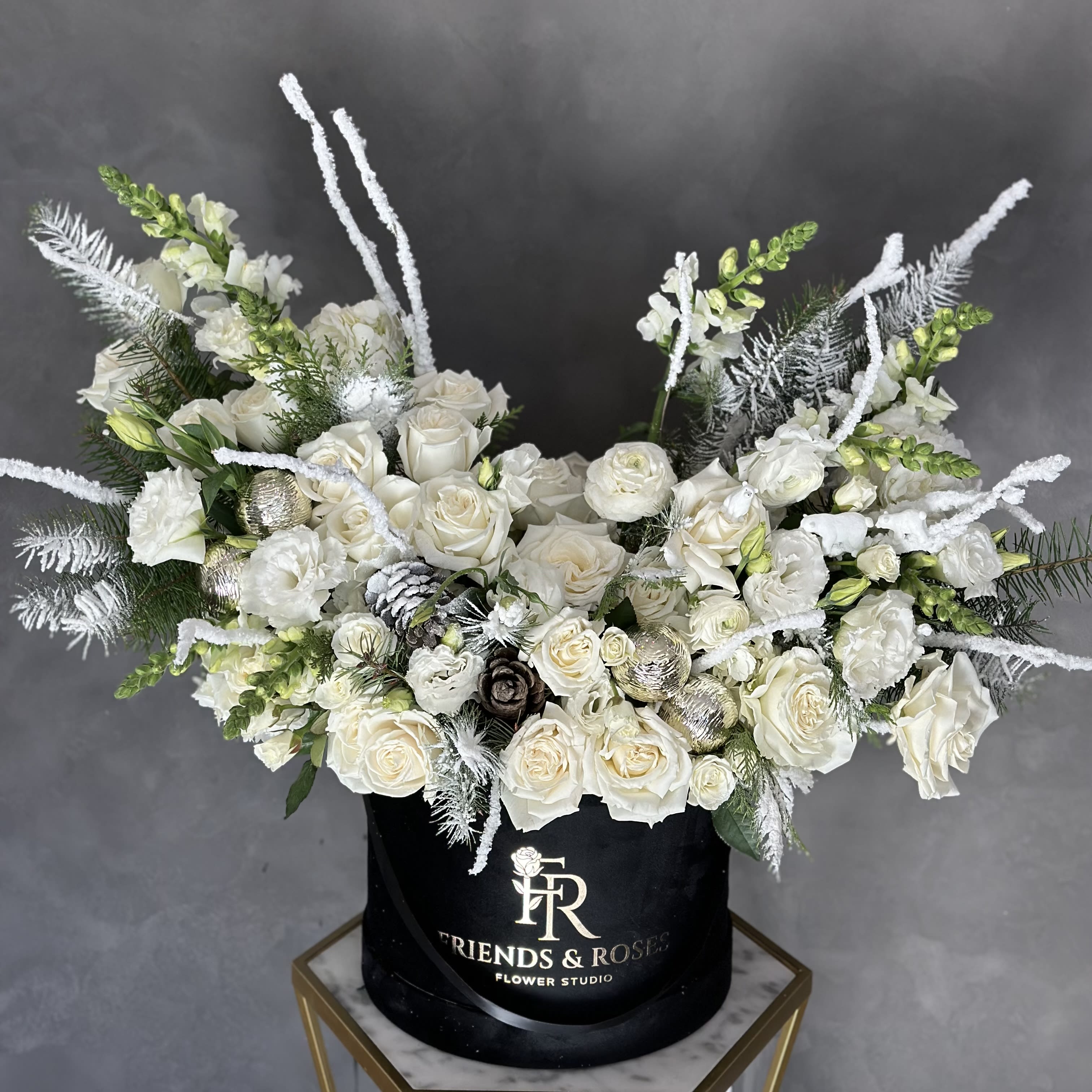 North Pole Express - Our large black signature box contains a stunning holiday arrangement made up of premium flowers, Christmas tree branches, little polar bears, and other trinkets. Masterwork by our best florist. A truly unique present for your friends and family members or home accent  