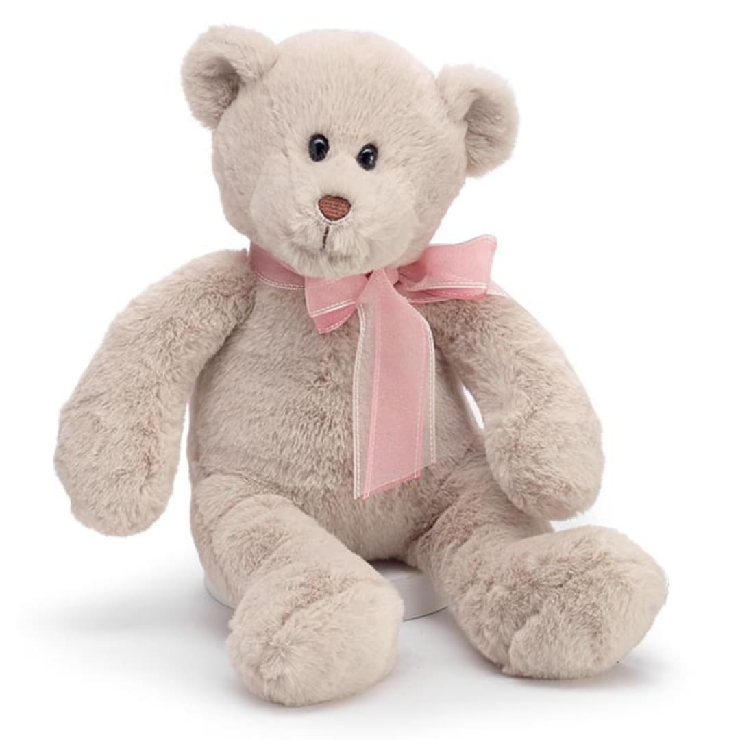 Softest Teddy  - Beige plush bear with a brown embroidered nose and pink and brown sheer ribbon tied in a bow around the neck. 14" High. 10" high sitting.