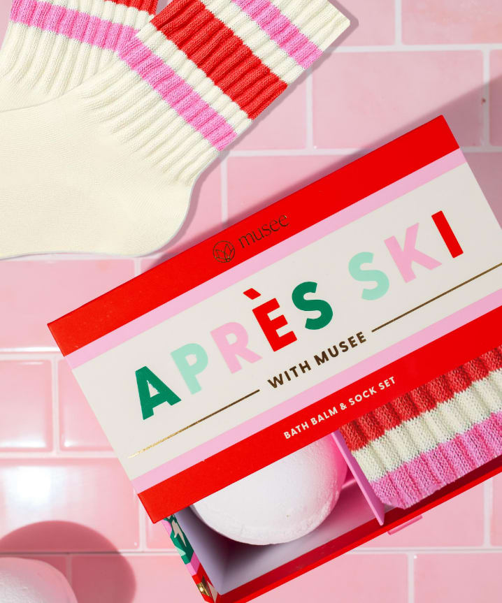 Apres Ski Bath Balm &amp; Sock Set - Musee | Apres Ski Bath Balm &amp; Sock Set  Winter just got way more fun with Musee's new holiday collection! Musee Bath Balms are handcrafted with natural ingredients that are always safe for all skin types and are thoughtfully designed to create moments of happiness and relaxation. Special surprises inside each balm! This set features a Marshmallow scented bath balm with a surprise ski charm!   Same-day delivery available throughout Wilmington and nearby areas including Greenville, Hockessin, Newark, and the Brandywine Valley Whether you’re looking for a thoughtful hostess gift, a luxury home accent, or something simply beautiful to brighten someone’s day, Petals offers fine gifts and personalized service that make every occasion memorable. Visit our Wilmington boutique or shop online today — and see why Petals is Delaware’s trusted name for fine gifts and inspired giving.