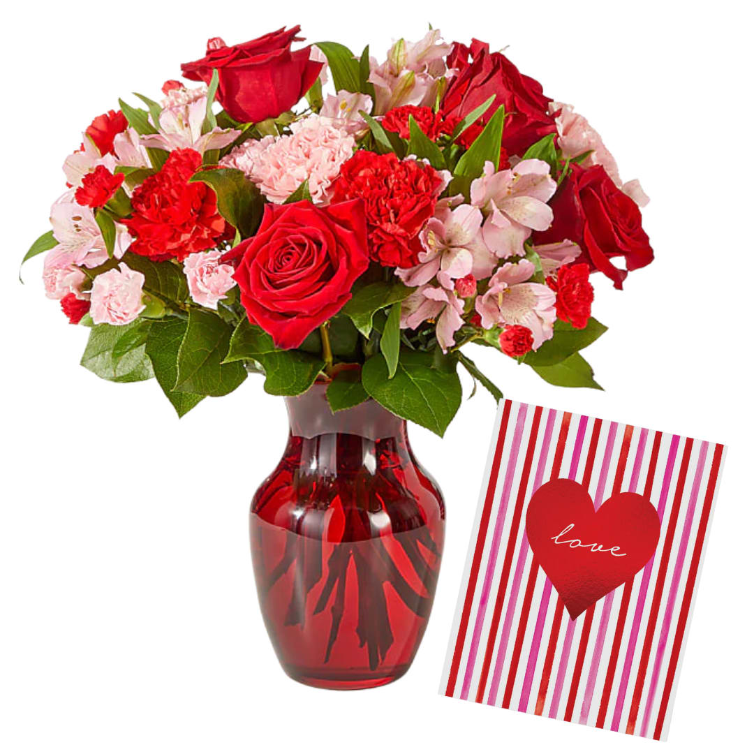 Sweetheart Card Bundle - Celebrate Valentine’s Day with a lush blend of classic romance and soft elegance paired with a full sized hand painted greeting card. This stunning arrangement features radiant red roses paired with delicate pink and red carnations and alstroemeria, symbolizing love, admiration, and devotion. Designed in a rich glass vase and accented with fresh greenery, this bouquet makes a heartfelt statement that’s perfect for expressing love, passion, and appreciation. A timeless choice for Valentine’s Day or any romantic occasion.
