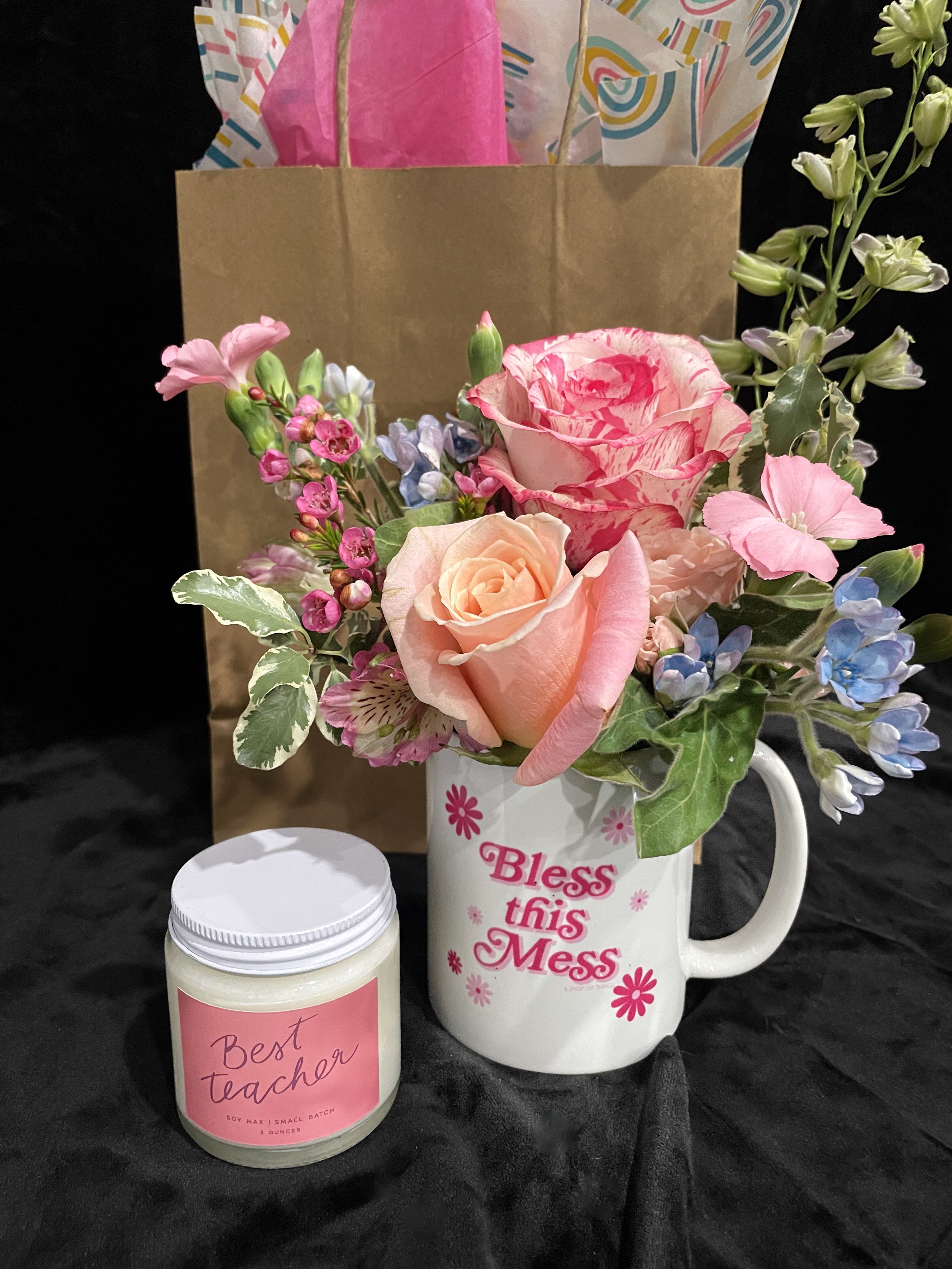Bless This Mess/Candle Combo - This charming gift set features a Flower Garden candle paired with a “Bless This Mess” mug, thoughtfully filled with a cheerful arrangement of fresh, seasonal flowers. Blooms and varieties may vary depending on availability, but the overall look will always remain bright, garden-inspired, and uplifting.  Perfect for birthdays, thank-you gifts, housewarmings, or just because, this floral candle gift is made to order and designed for freshness. We offer reliable same-day or next-day flower delivery in Bowling Green and surrounding areas, making it easy to send a thoughtful gift to homes, workplaces, or special recipients nearby.  Support a local florist while sending a flower-filled gift that brings warmth, fragrance, and joy.  Candle Details  A fresh floral fragrance with green brightness, soft woods, and a warm amber finish.  Fragrance Profile: Top: Marigold, Bergamot Middle: Cedar Leaf Base: Amber, Sandalwood Essential Oils: Orange  Product Details: 8 oz Soy blend candle Made in St. Augustine, Florida Small-batch production Dye-free Phthalate-free fragrance oils Organic cotton wick  Burn Time: Approximately 55 hours