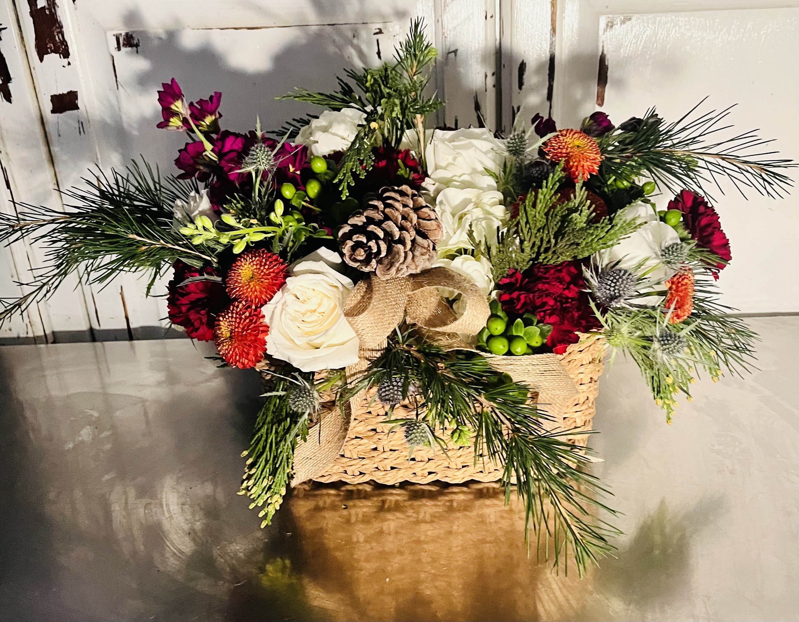 Warm and cozy - This fall design evokes warm and cozy feelings of distant pleasant memories  Assorted holiday greens and flowers spilling over a soft, open weave basket sure to bring a smile to their face and the spirit of Thanksgivings gone by.