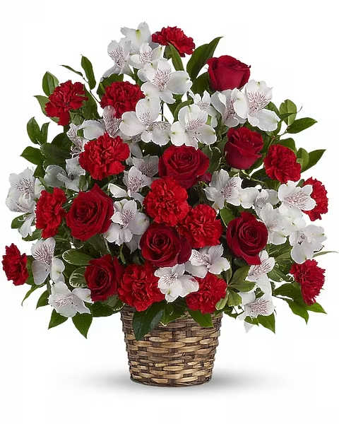 Beauty and Devotion Bouquet - Strength, spirit, enduring hope and dignity are all on brilliant display in this striking red and white arrangement. Your life-affirming thoughtfulness will be much appreciated. Elegant red roses and carnations, white alstroemeria, pittosporum and salal are lovingly delivered in a natural wicker basket.   Orientation : One-Sided  All prices in USD ($)  Due to an increase in the cost of roses, some product prices may be impacted during the Valentine’s delivery period.