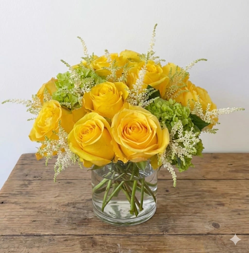 Golden Birthday  - Simplicity is key. This elegant flower arrangement in a vase features the beautiful yellow rose, a symbol of friendship, accented with classic green hydrangea. Show your closest friends how much they mean to you with this bright and colorful bouquet. Vase will vary based on availability.