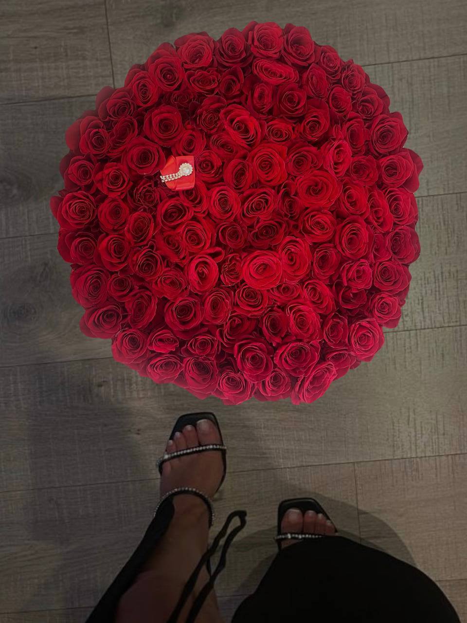 100 Red Roses in a Box - 100 Red Roses in a Box – A Symbol of Passion and Luxury  This arrangement is the ultimate expression of love, passion, and devotion. 100 vibrant red roses are elegantly placed in a sleek black box, creating a stunning contrast that captivates at first sight. The deep, velvety petals, exquisite shape of the blooms, and rich fragrance make this gift truly unforgettable.  Perfect for romantic declarations, anniversaries, birthdays, or any moment when words aren’t enough to say “I love you.”