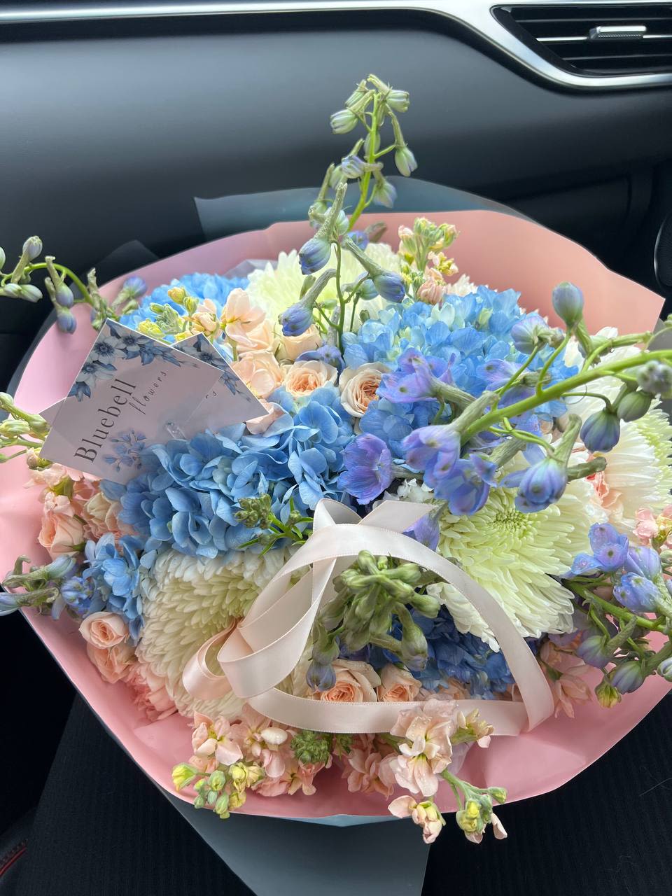 Cloud Garden - Cloud Garden A dreamy pastel bouquet featuring sky-blue hydrangeas, soft peach spray roses, airy delphinium, fluffy chrysanthemums, delicate carnations, and fragrant stock flowers. As gentle as a morning breeze and as serene as a garden floating among the clouds — perfect for moments that call for tenderness and grace.