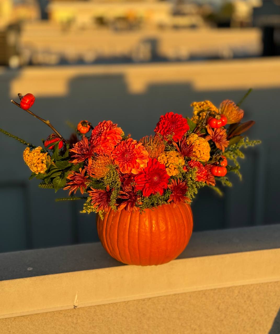 Pumpkin - Pumpkin is a cozy autumn arrangement filled with warmth and the golden essence of the season. Vibrant orange and deep red flowers blend harmoniously with natural greenery, creating a feeling of comfort and festive charm. The highlight of the bouquet is the pumpkin itself, serving as a unique vase that perfectly captures the autumn spirit.  This arrangement is ideal for home décor, a seasonal gift, or a stylish centerpiece for Halloween and Thanksgiving celebrations. Pumpkin is a symbol of warmth, coziness, and the beauty of fall in every petal.