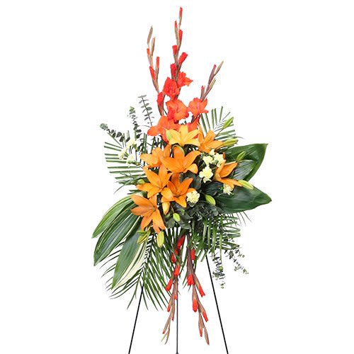 Warm Memories - Bright and bold standing spray featuring vibrant orange lilies, fiery red gladiolus, and fresh tropical greens—an elegant tribute that brings warmth, love, and heartfelt remembrance. 