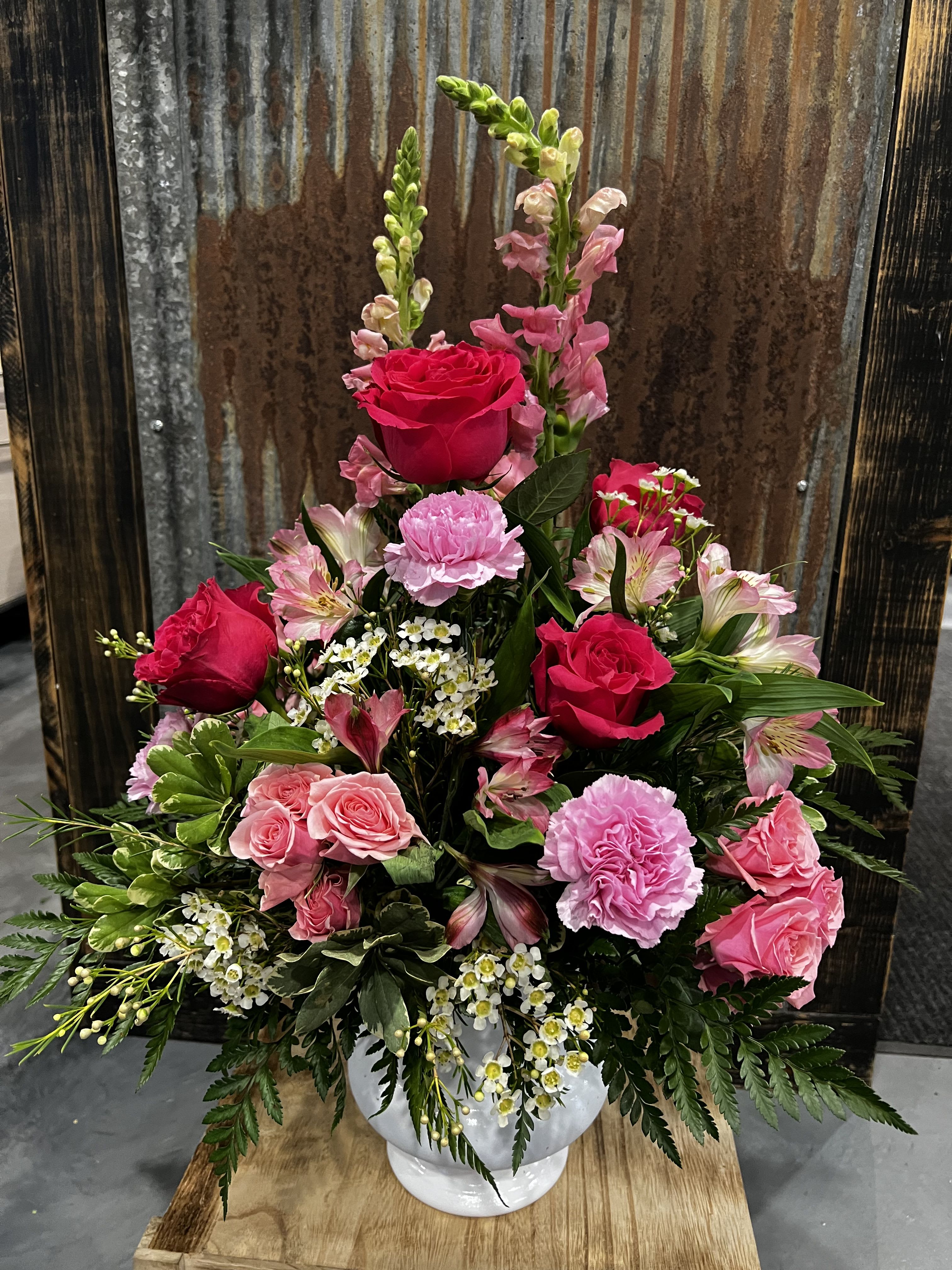 Grace in Pink  - This elegant arrangement features a beautiful blend of rich and soft pink blooms, thoughtfully designed in a classic white container. 