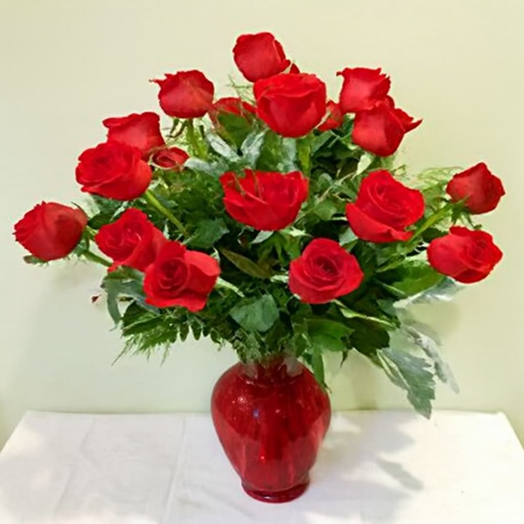 Valentine's Day Two Dozen Roses - PREORDER - Our Signature Two Dozen Elegant Red Roses in a festive Red vase for your Valentine! This luxurious arrangement features 24 of the finest long-stemmed red roses, expertly arranged with lush foliage to showcase their natural beauty and grace. The rich red hue of the roses symbolizes deep love, passion, and admiration, making it the perfect gift for a grand romantic gesture or simply to express your love and appreciation.  Available after 02/06/2026 