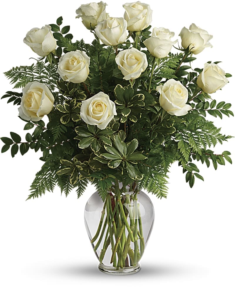 Joy Of Roses Bouquet - A joyful gesture of love and affection, this chic arrangement of one dozen pure white roses with fresh greens is a special surprise on any occasion. 12 white roses are arranged with leatherleaf fern, huckleberry and variegated pittosporum. Delivered in a clear vase.
