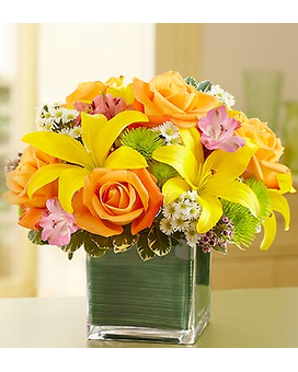 SPRING IN A CUBE - It's easy to picture the beauty of a perfect Autumn day in Europe with this vibrant arrangement of roses, lilies, alstroemeria, poms and more, arranged in a stylish cube bouquet lined with an exotic ti leaf ribbon. A beautiful addition to any celebration. 