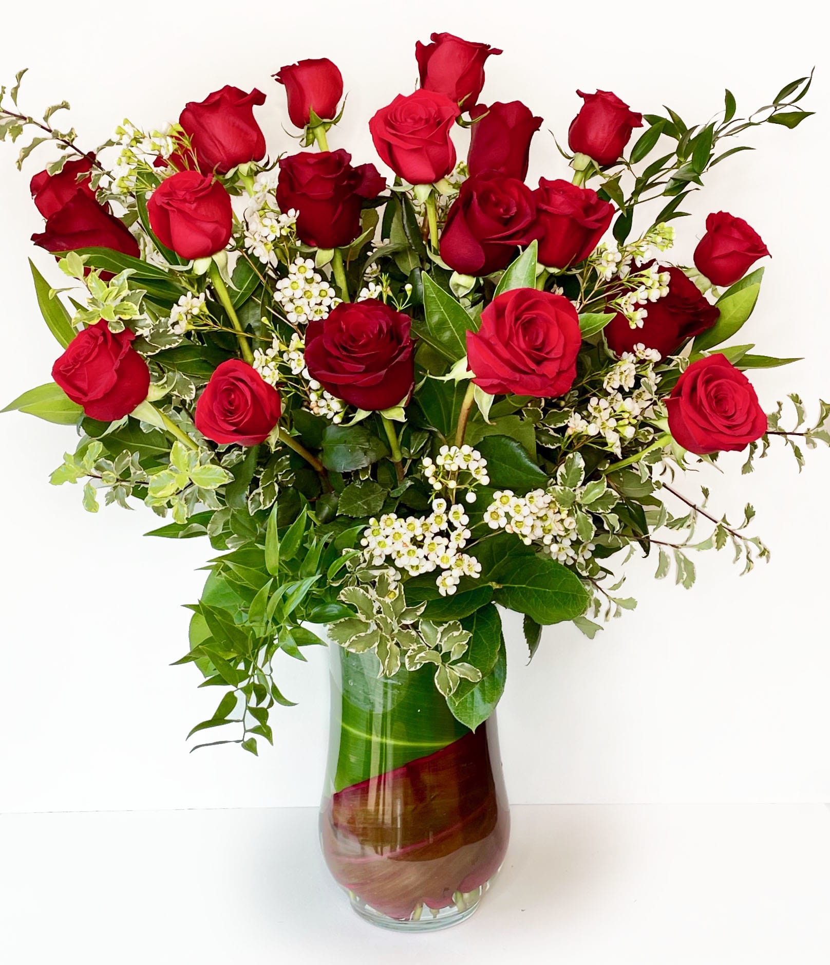 Forever Flawless   - Double her pleasure, double her fun with two dozen gorgeous red roses arranged in a sparkling clear glass vase. This truly breathtaking gift will make her fall in love with you all over again
