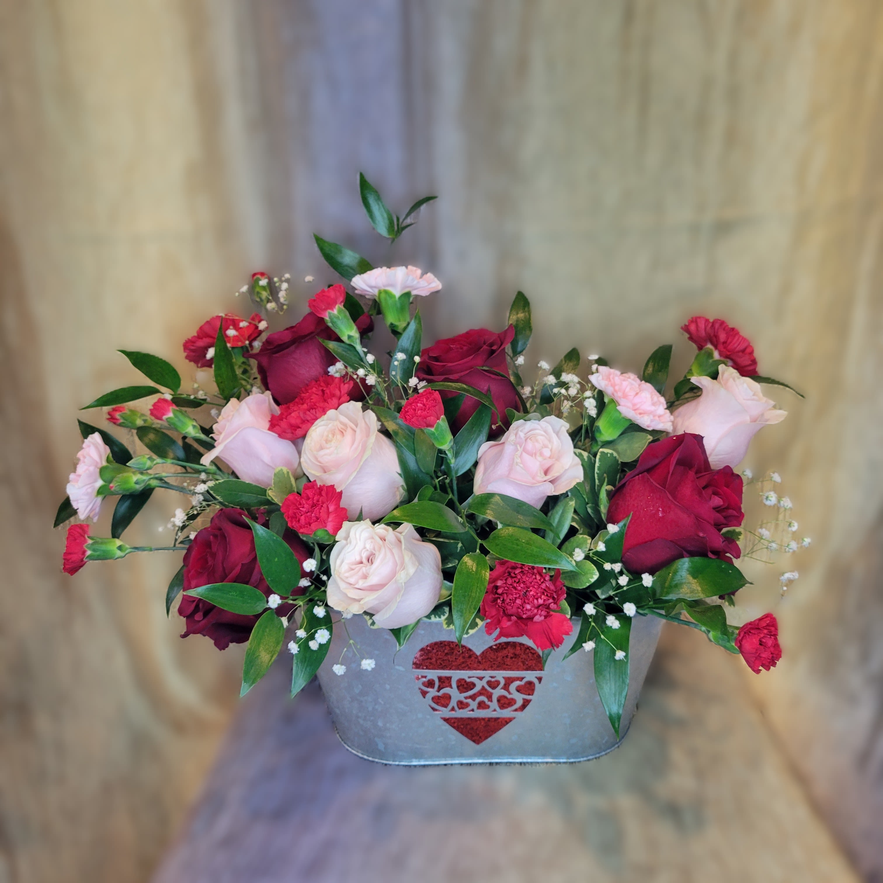 Glittering Heart - PREORDER - A delightful mix of pinks and reds including roses, carnations and baby's breath arranged in a glittering heart keepsake container.  Perfect for a romantic gesture of affection, and celebrating love’s sweetest moments.  Available after 02/06/2026 