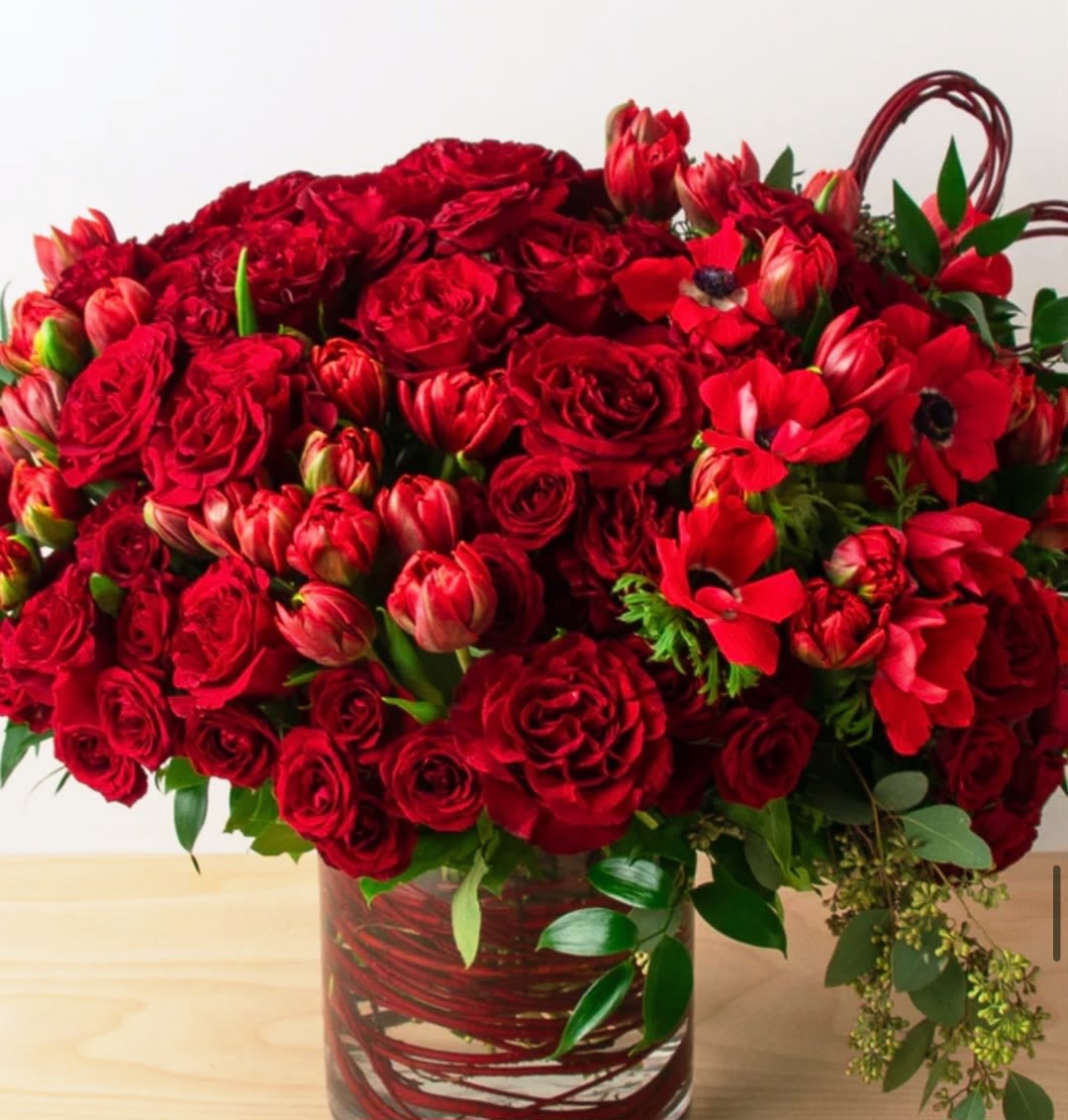 Red Passion - Who doesn't know the intense charm of red? Fall for the red charm of passion.  All mix of red color fresh flower. Red Roses, Spray red roses, Tulips, Anemones in a vase. 