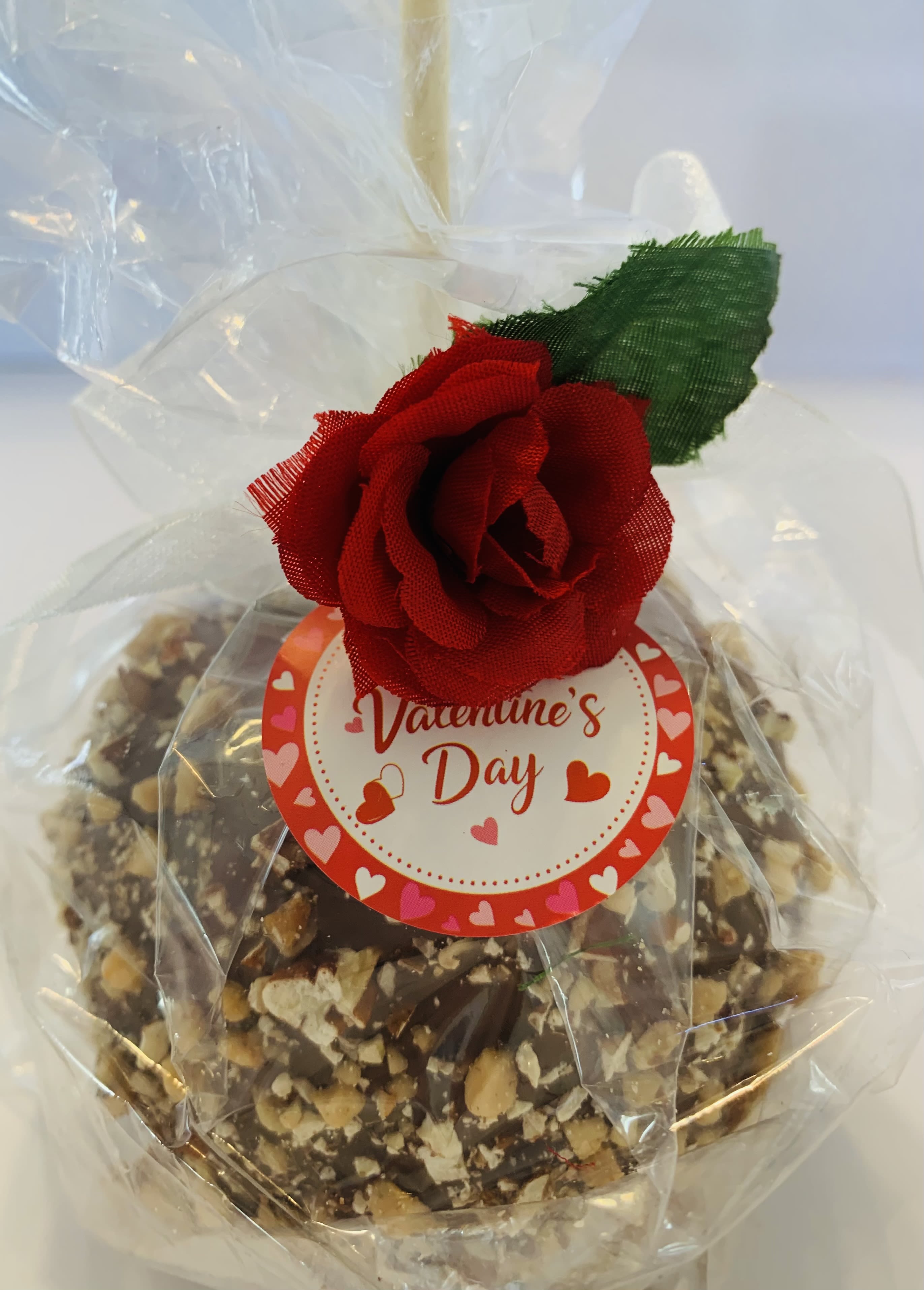 Milk Chocolate with Toffee and Pecans Caramel Apple **Support Local Fundraiser** - Crisp apple dipped in caramel and milk chocolate, coated with Toffee and Pecan bits. Perfect with flowers and even sweeter knowing proceeds support a local fundraiser for a Humanitarian trip! **** AVAILABLE FEBRUARY 9-14TH****
