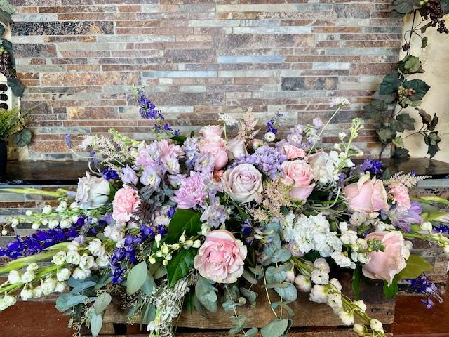 Sweetest Memories Lavender Casket Spray - This piece is created specifically to adorn a casket. It's designed intentionally and with care to honor the memories of your loved one with a lovely variety of soft flowers. 