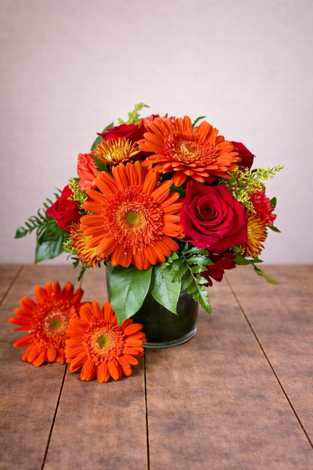 Hot And Spicy  - Uniquely hand-created by our experienced designers this beautiful arrangement of happy peach Gerber daisies, lovely red roses and filler flowers make this a go-to for the fall season. Please note that every design is custom made and substitutions to container and flower types may happen from time to time. Design aspects will always stay the same, but if needed, we will substitute with flowers of equal or greater value to offer you a great floral shopping experience! Our flowers are 100% guaranteed. Please call us with any questions or concerns.