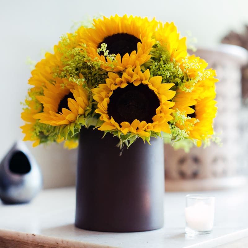 Pure Sunshine - A mound of cheery sunflowers in a ceramic container, perfect to brighten someone's day.