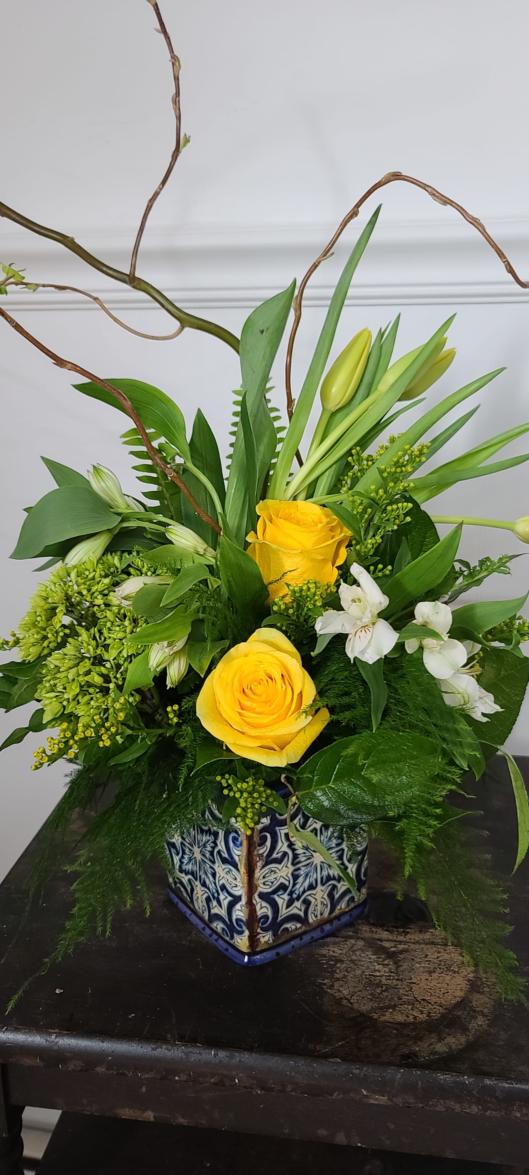 A hint of Morocco - The cool blues in the tile inspired vase of this arrangement lend a Moroccan vibe that lifts the spirits. Alstromaria, yellow roses, green hydrangea, and tulips bring warmth and renewed energy to any space. 