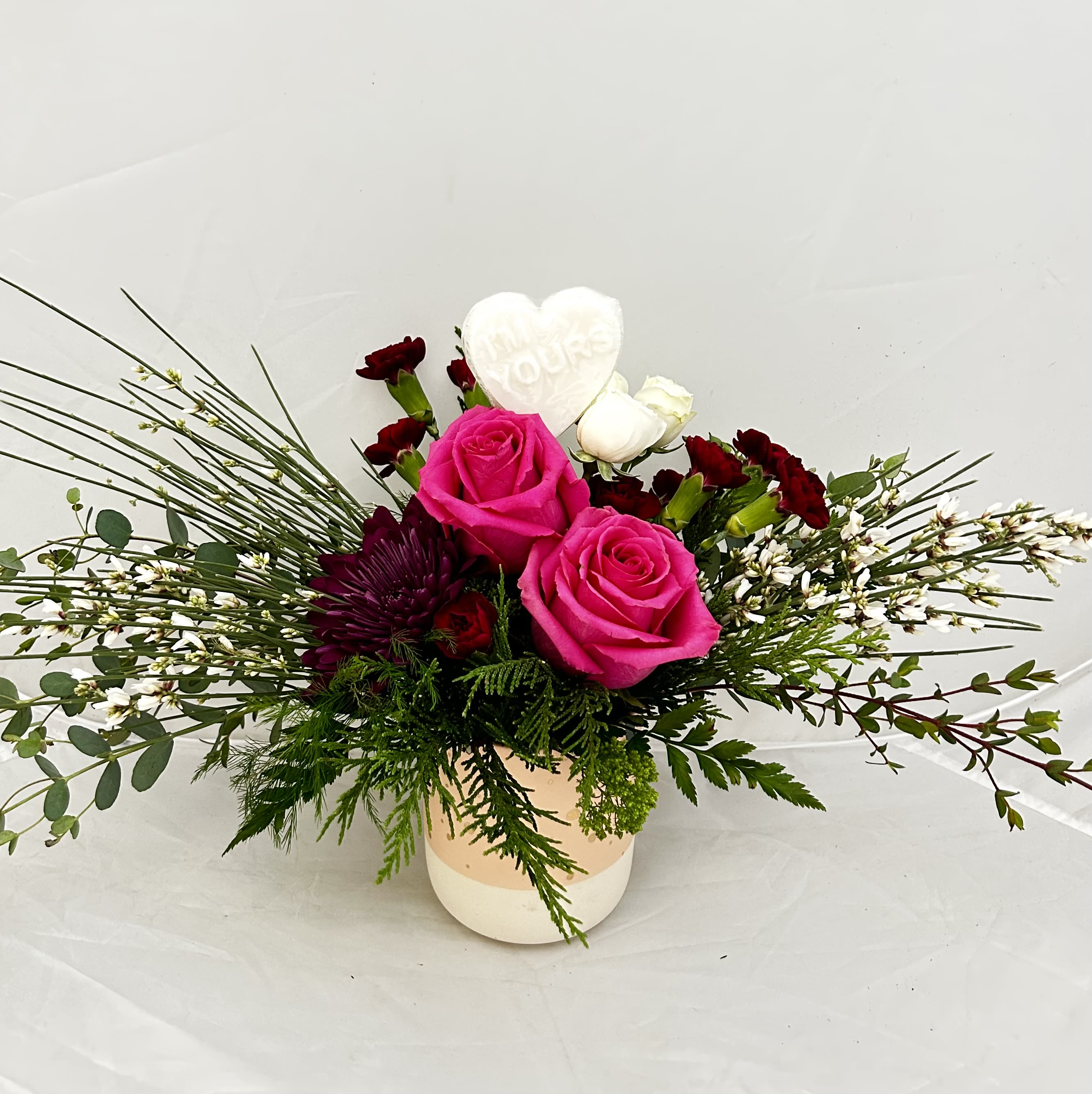 I'm Yours - Speak the language of love with this captivating and heartfelt arrangement. "I'm Yours" is a stunning display of affection, featuring premium blooms in a palette of romantic reds and soft pinks. Designed to make a lasting impression, this piece combines classic elegance with a modern flair, making it the ultimate declaration of devotion for birthdays, anniversaries, or "just because."