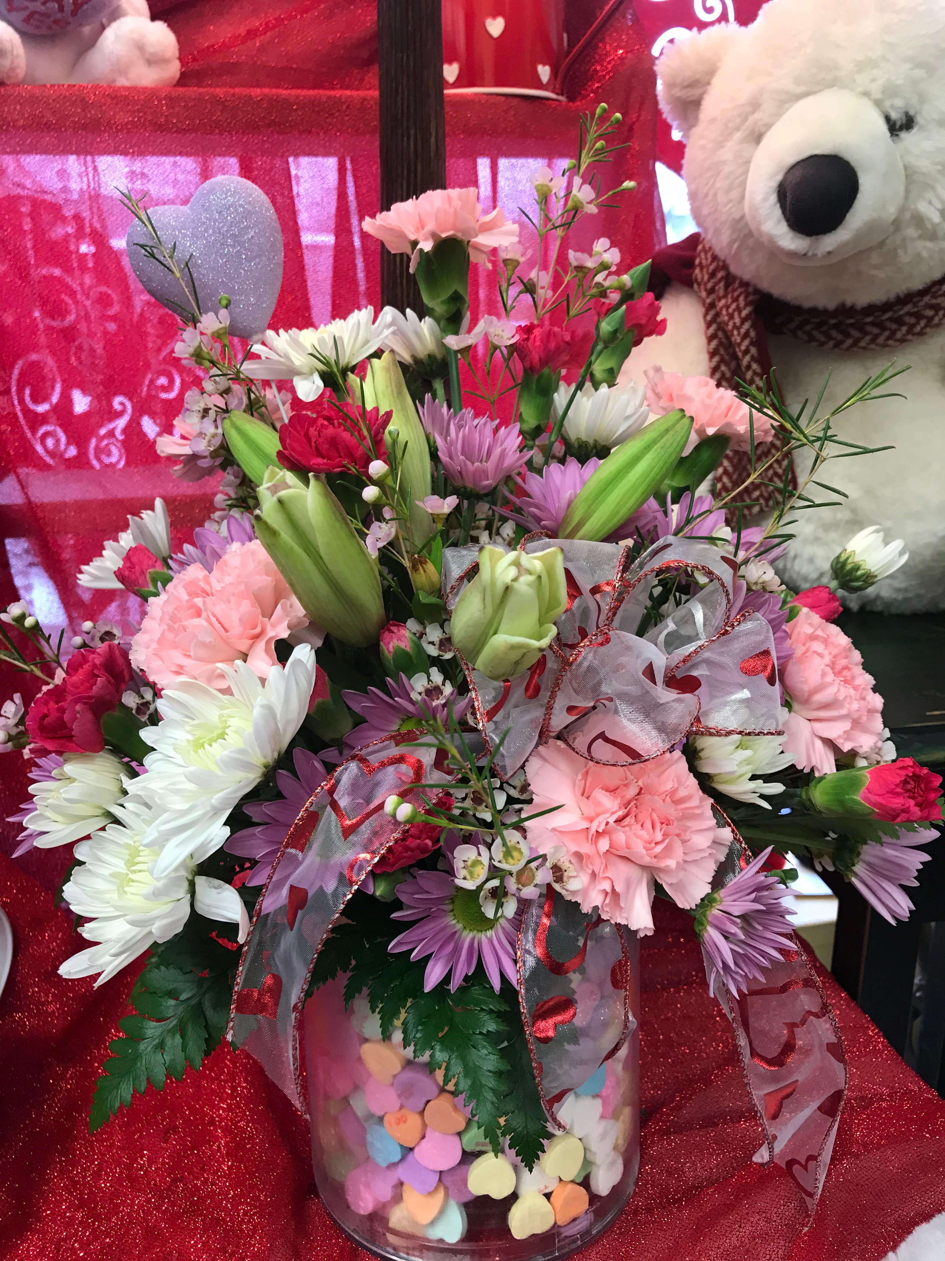 Sweet Sentiments Bouquet  - Perfect for your sweetie - this colorful arrangement of a variety fresh flowers arranged in a container filled with sweet sentiment candy hearts - while supplies last - bear not included