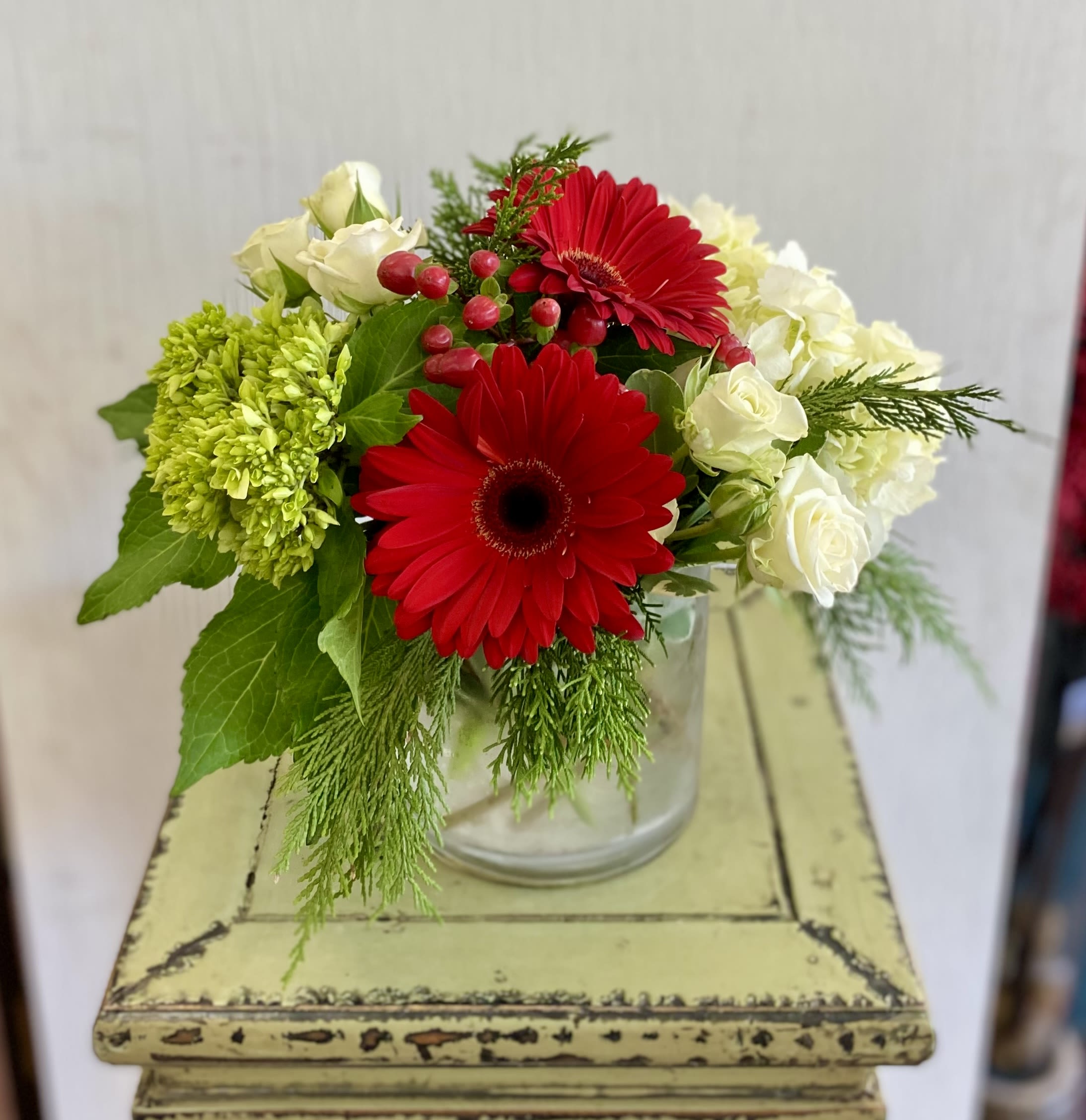 Ruby Skies - A pretty arrangement of gerbers, hydrangea, roses, and more, arranged in a clear cylinder vase. 