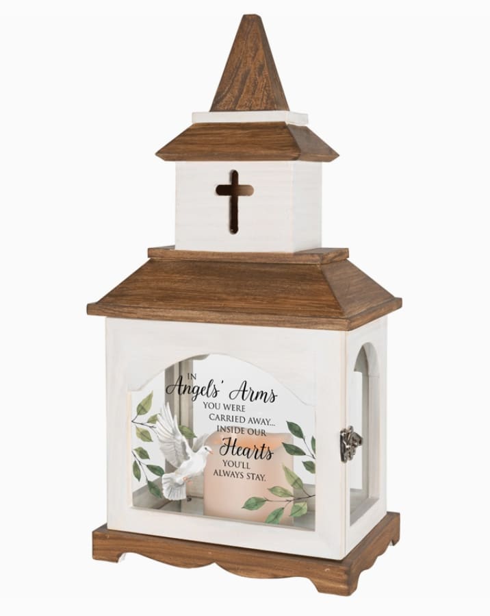 Memorial Lantern - In Angel's Arms - These lanterns are made from quality wood and uv printed glass artwork with sentiment. The flameless LED candle features a built in automatic timer 6 hours ON/18 hours OFF. 3 AAA batteries are included. These lanterns are intended for indoor use only. Lantern Reads: "In angels' arms you were carried away... inside our hearts you'll always stay."  Approx 9x6x18