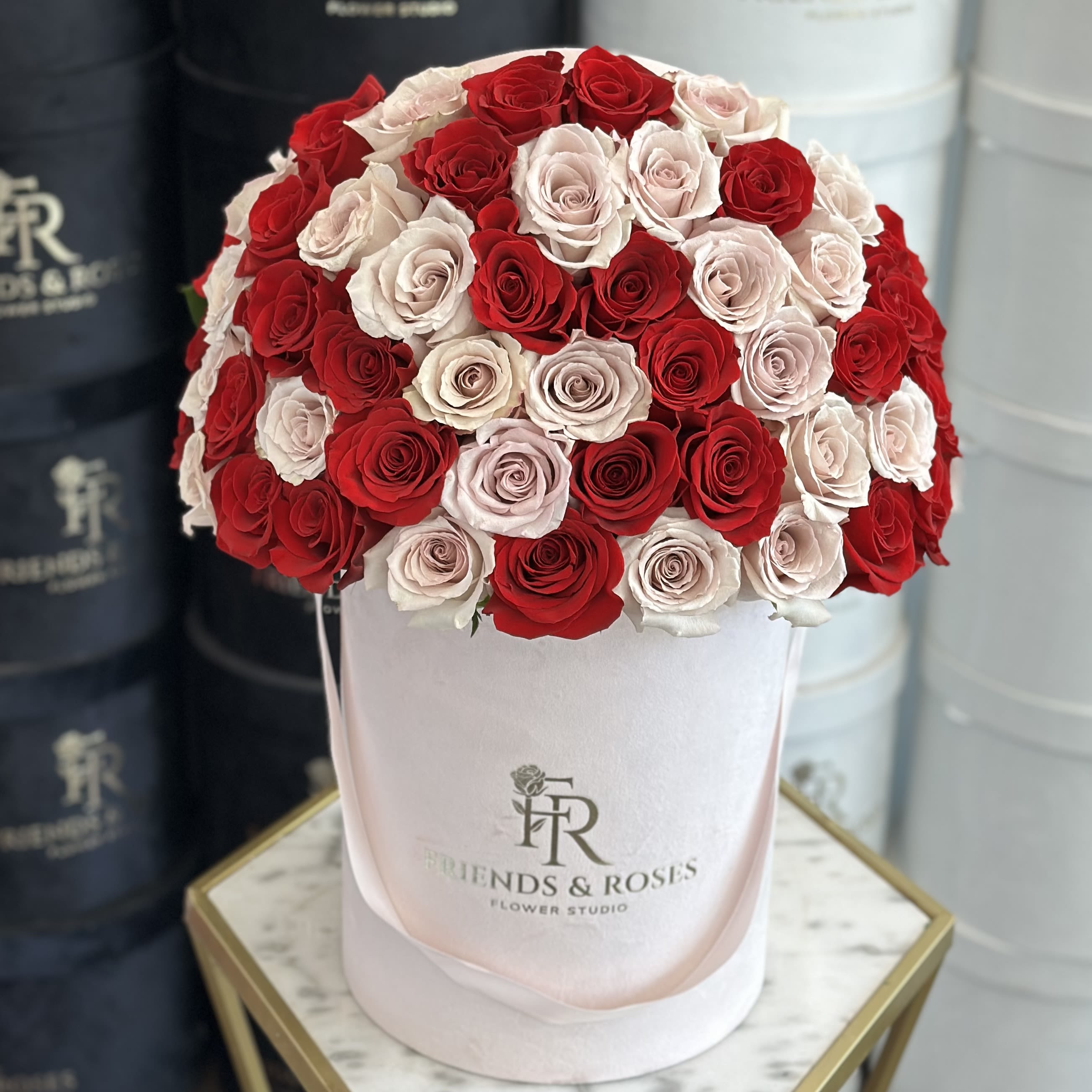 Miranda - Experience timeless luxury with our signature floral box - an exquisite blend of deep red roses and elegant Quicksand roses, curated to captivate and impress.